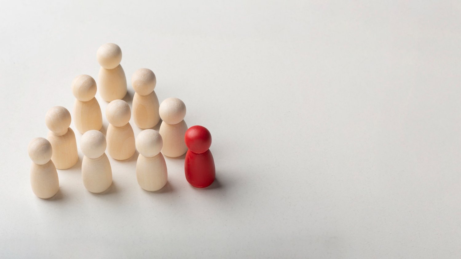 Ilustração de várias peças de jogo, com uma peça vermelha destacada, simbolizando a importância de segmentar sua lista de contatos para campanhas mais eficazes.